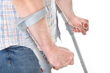 Man walking with a crutch